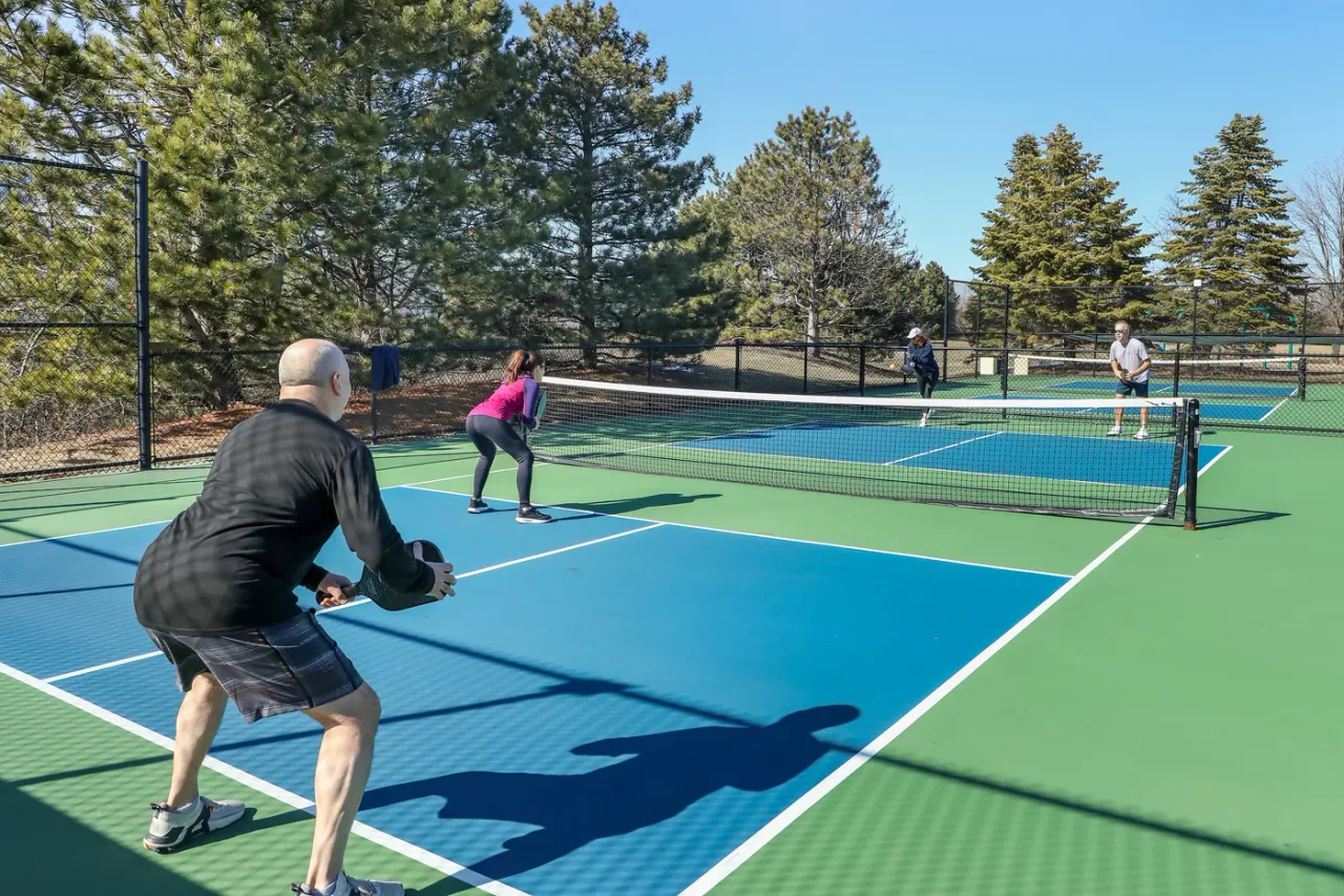 Friends playing a doubles pickleball match