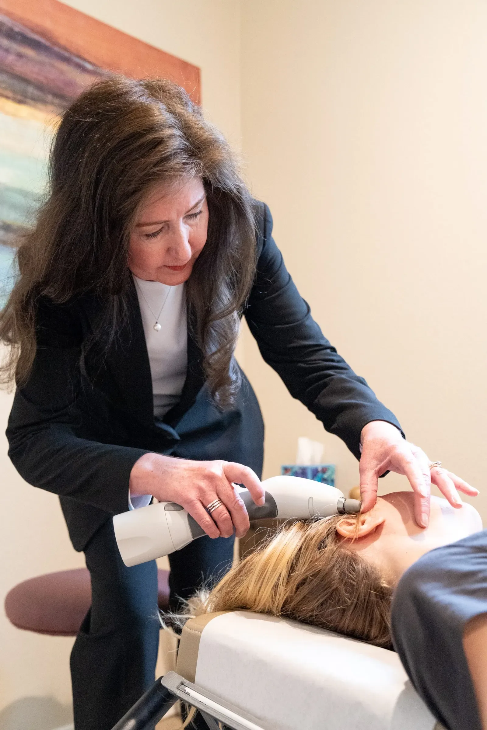 Chiropractor performing hands-on neck adjustment on patient
