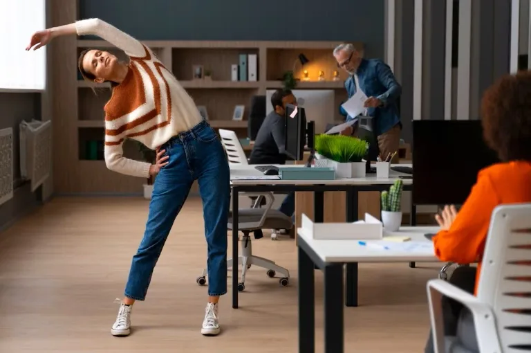 A woman stretching during a break at the office